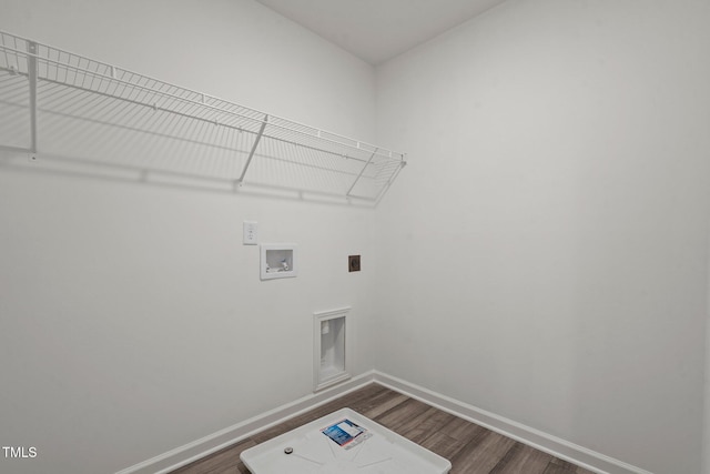 washroom with dark wood-style flooring, hookup for an electric dryer, baseboards, and washer hookup