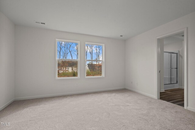unfurnished bedroom featuring carpet flooring and baseboards