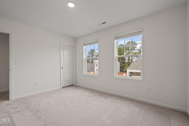 spare room featuring baseboards and carpet flooring