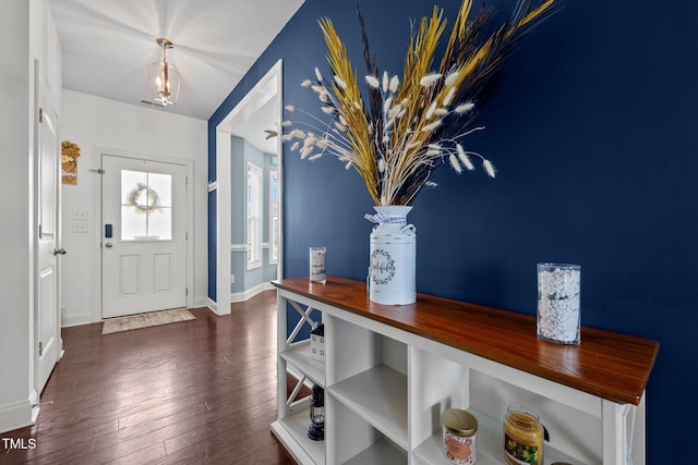 entrance foyer with baseboards and dark wood-type flooring