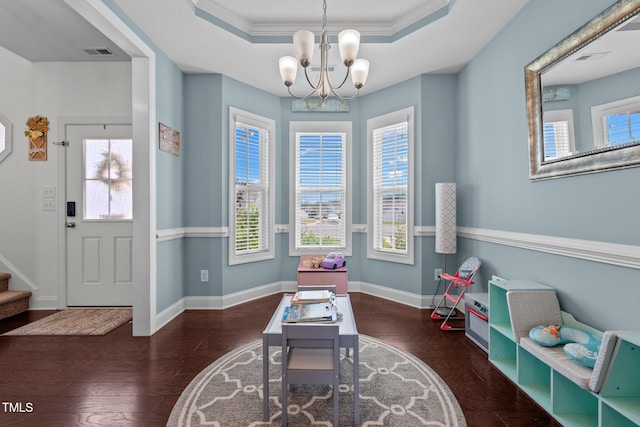 interior space with an inviting chandelier, wood finished floors, visible vents, and baseboards
