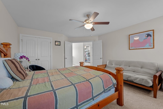 carpeted bedroom with a ceiling fan and a closet