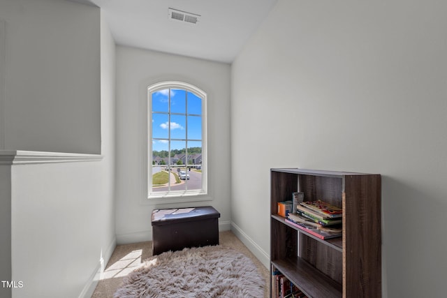 interior space with baseboards, visible vents, and carpet floors