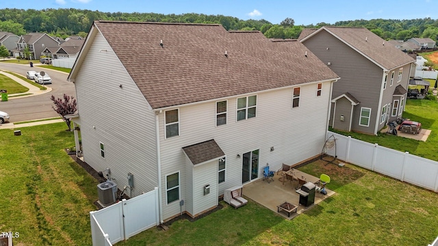rear view of property featuring cooling unit, a patio, a residential view, a yard, and a fenced backyard