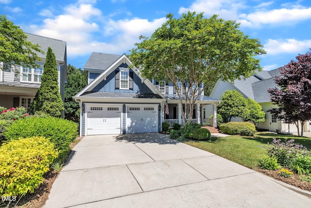 craftsman-style house with a shingled roof, a front lawn, a garage, a porch, and driveway