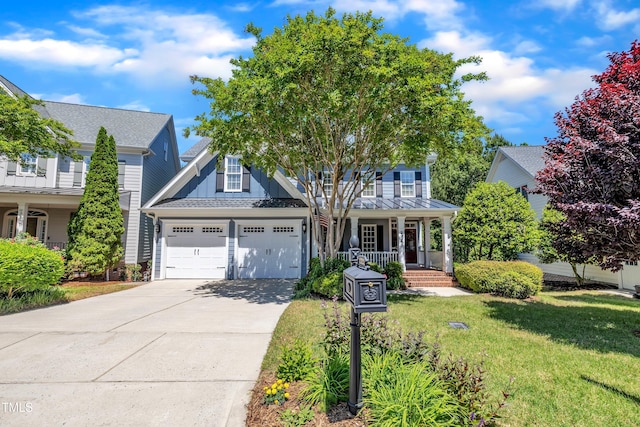 view of front facade featuring a garage, a front yard, board and batten siding, concrete driveway, and a porch
