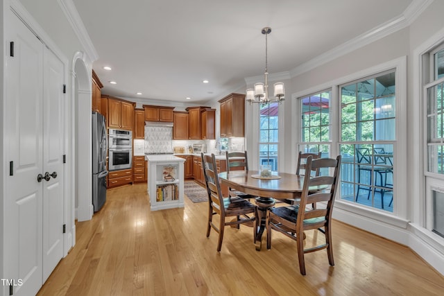 dining area featuring crown molding, recessed lighting, a notable chandelier, and light wood-type flooring