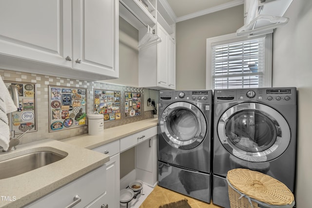 laundry room with ornamental molding, light tile patterned flooring, cabinet space, and washer and clothes dryer