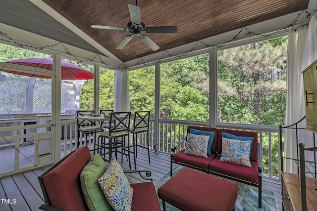 sunroom / solarium featuring an outdoor living space, a ceiling fan, a wealth of natural light, and wine cooler