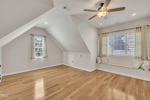bonus room with visible vents, lofted ceiling, wood finished floors, baseboards, and a ceiling fan