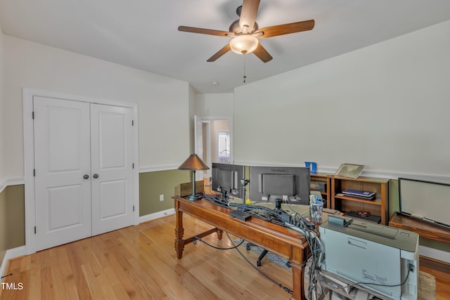 home office with baseboards, ceiling fan, and wood finished floors