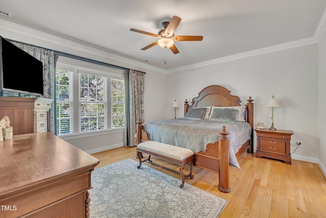bedroom featuring baseboards, ornamental molding, light wood finished floors, and a ceiling fan