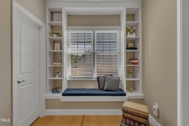interior space featuring baseboards and wood finished floors
