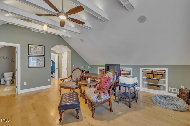 sitting room featuring wood finished floors, vaulted ceiling with beams, ceiling fan, and visible vents