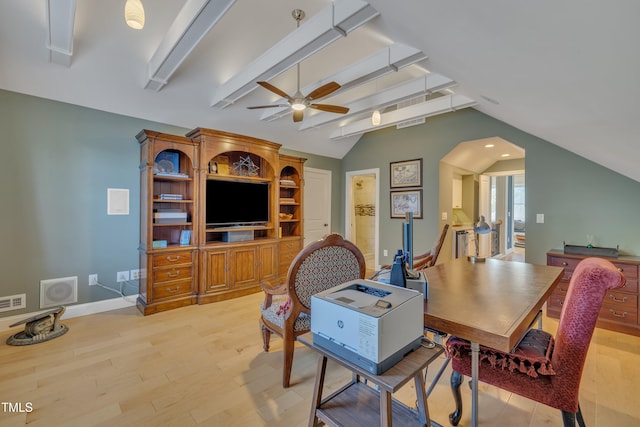interior space featuring ceiling fan, baseboards, vaulted ceiling with beams, light wood-type flooring, and visible vents
