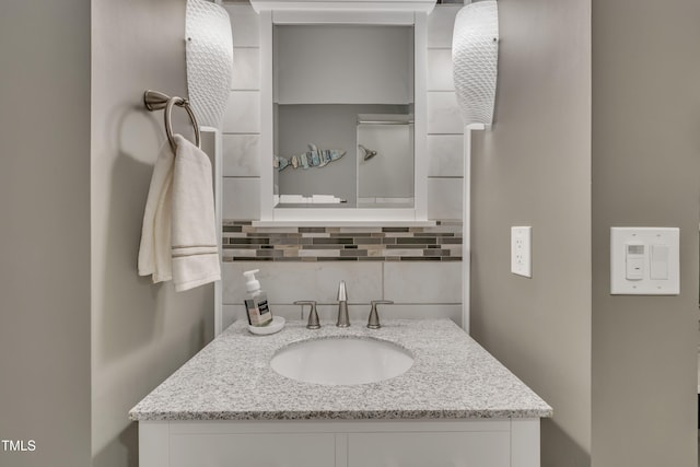 bathroom with vanity and tasteful backsplash