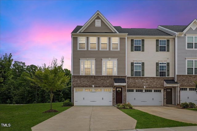 260 Amber Acorn Ave, Raleigh, NC 27603 - view of front facade featuring brick siding, driveway, a lawn, and an attached garage
