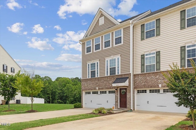 260 Amber Acorn Ave, Raleigh, NC 27603 - townhome / multi-family property featuring concrete driveway, brick siding, and a garage