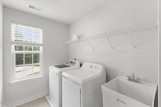 260 Amber Acorn Ave, Raleigh, NC 27603 - laundry area with washing machine and dryer, baseboards, and light tile patterned floors