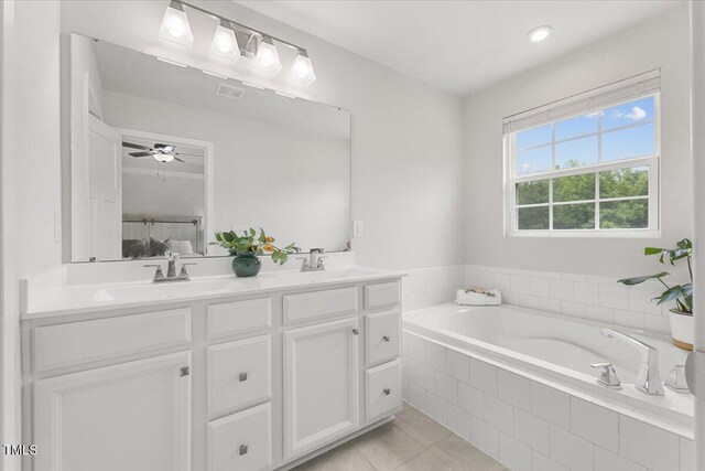 260 Amber Acorn Ave, Raleigh, NC 27603 - bathroom with double vanity, tile patterned floors, a bath, and a ceiling fan