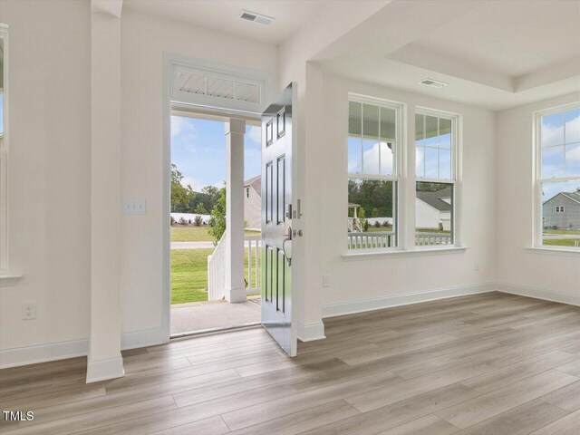 doorway to outside featuring visible vents, wood finished floors, and baseboards