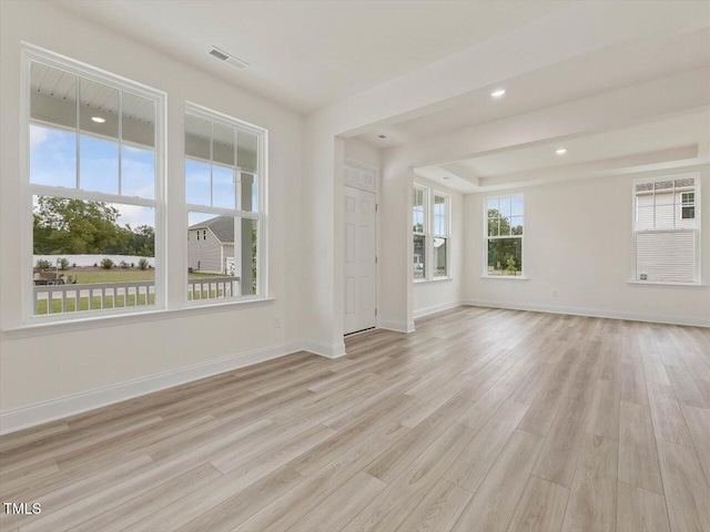 unfurnished room with baseboards, visible vents, light wood-style floors, and recessed lighting