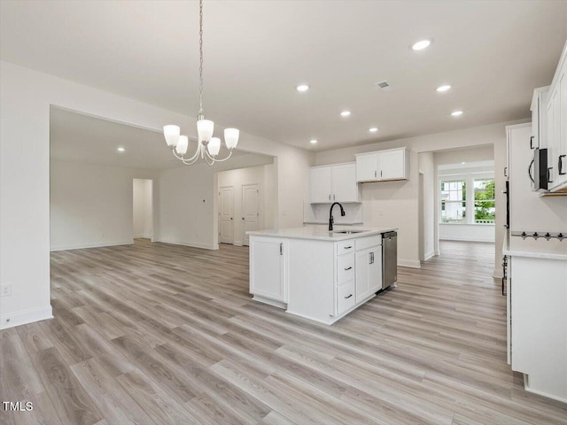 kitchen featuring stainless steel dishwasher, light wood-style flooring, a sink, light countertops, and an inviting chandelier