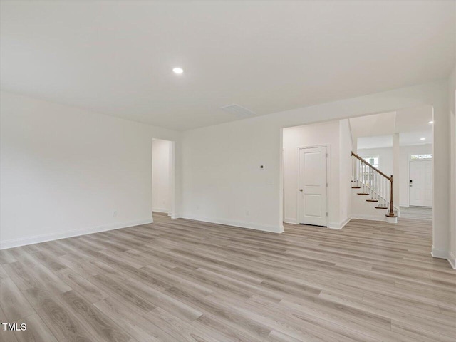 interior space with stairway, light wood-type flooring, recessed lighting, and baseboards