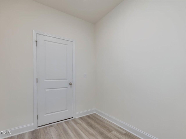 unfurnished room featuring light wood finished floors and baseboards