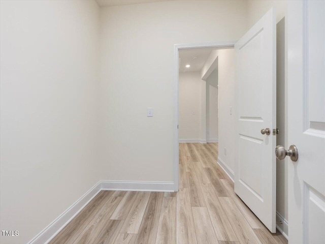 unfurnished room featuring recessed lighting, baseboards, and light wood-style floors