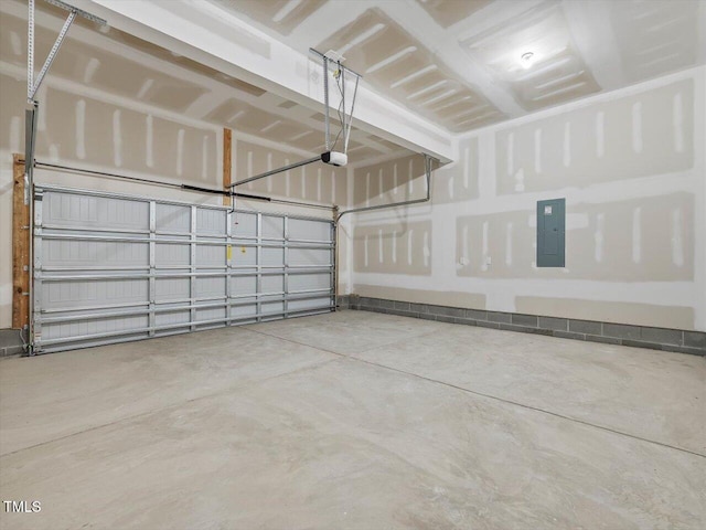 garage with a garage door opener and electric panel