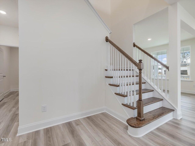 stairs featuring recessed lighting, wood finished floors, and baseboards