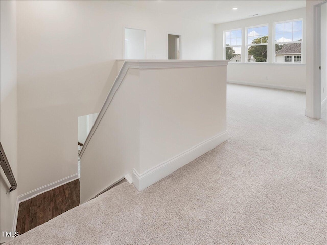 stairway featuring carpet flooring and baseboards