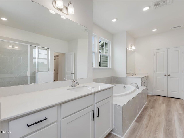 full bathroom with a garden tub, a stall shower, visible vents, and a healthy amount of sunlight