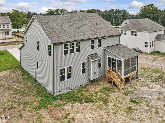 back of house with a shingled roof, central air condition unit, crawl space, a yard, and a sunroom