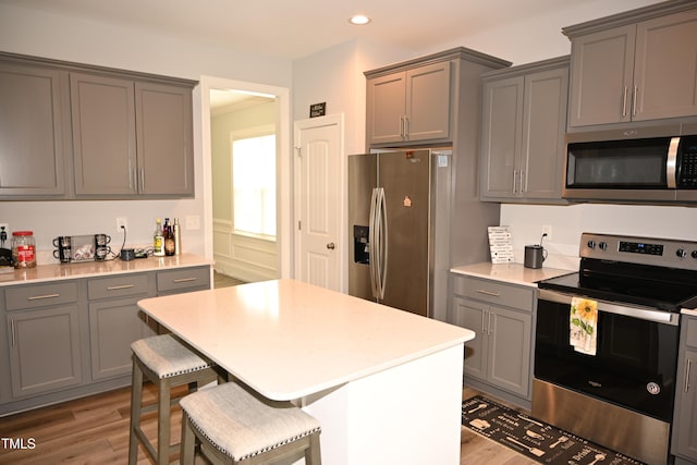 474 Ashpole Trl, Clayton, NC 27520 - kitchen featuring stainless steel appliances, gray cabinetry, wood finished floors, recessed lighting, and light countertops