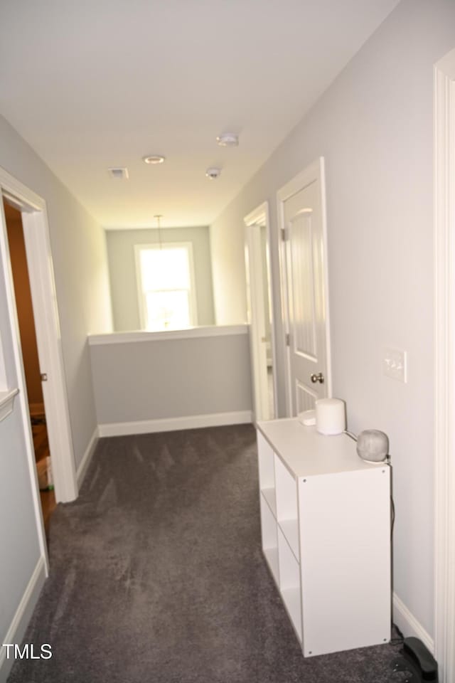 474 Ashpole Trl, Clayton, NC 27520 - corridor with dark colored carpet and baseboards