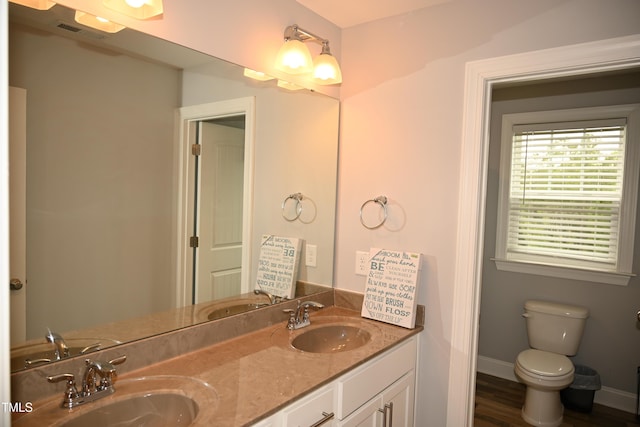 474 Ashpole Trl, Clayton, NC 27520 - full bath featuring double vanity, wood finished floors, toilet, and baseboards