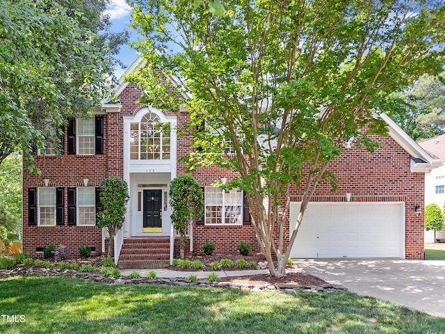 view of front of house with an attached garage, a front lawn, brick siding, and concrete driveway