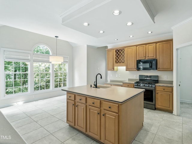 kitchen with black microwave, stainless steel gas range oven, a center island with sink, light tile patterned floors, and a sink
