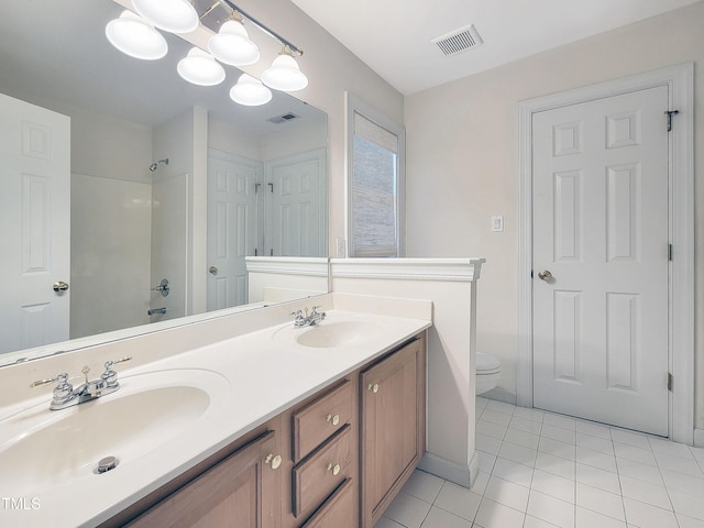 bathroom featuring a sink, tile patterned flooring, and visible vents