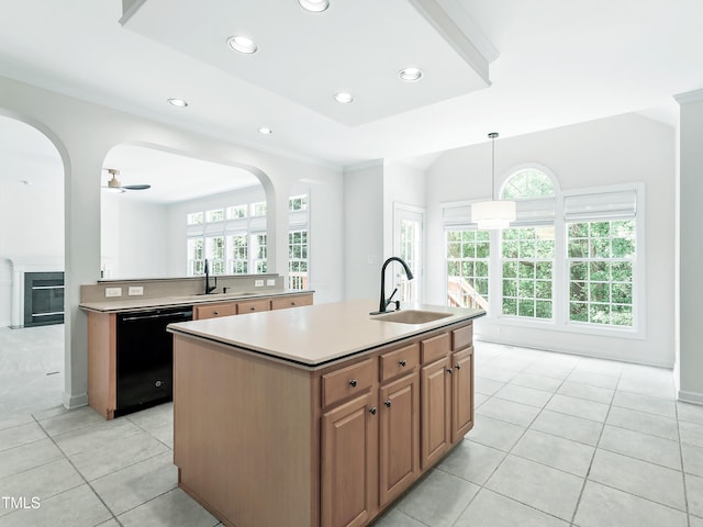 kitchen with black dishwasher, light tile patterned flooring, a healthy amount of sunlight, and a sink