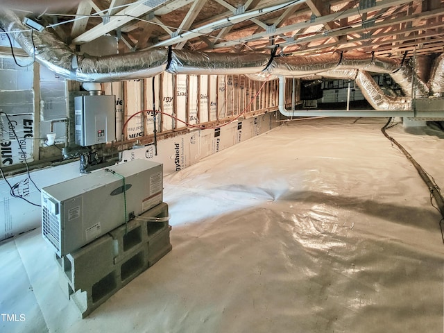 below grade area featuring heating unit and tankless water heater
