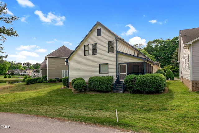 17 Nicklaus Way, Clayton, NC 27520 - view of home's exterior featuring a lawn and a sunroom