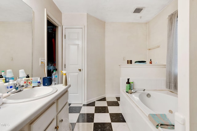17 Nicklaus Way, Clayton, NC 27520 - bathroom with visible vents, tile patterned floors, vanity, and a jetted tub