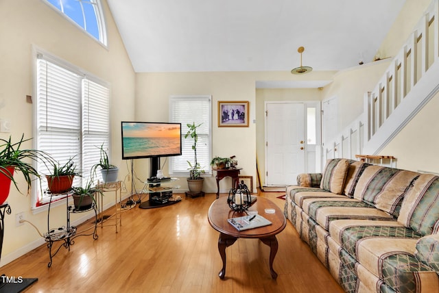 17 Nicklaus Way, Clayton, NC 27520 - living room with stairs, high vaulted ceiling, baseboards, and wood finished floors