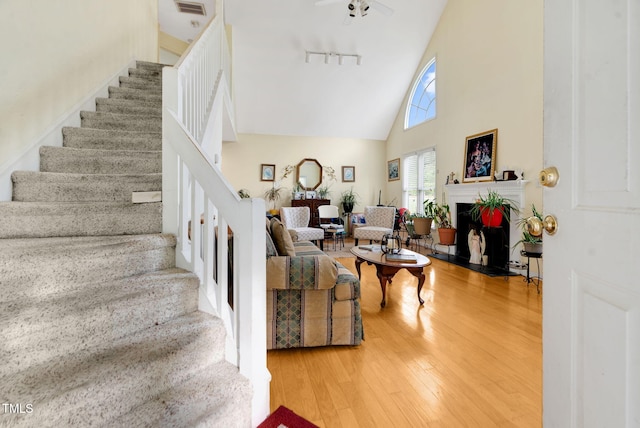 17 Nicklaus Way, Clayton, NC 27520 - interior space with high vaulted ceiling, a fireplace with flush hearth, rail lighting, and hardwood / wood-style floors