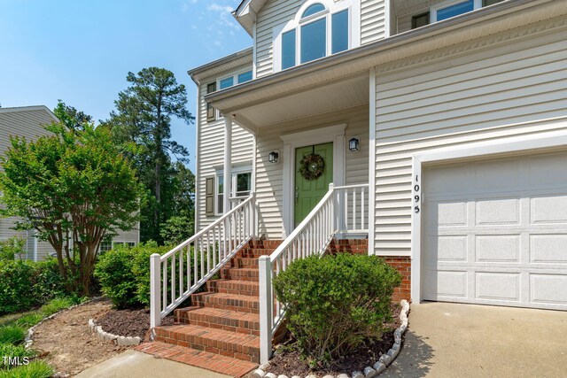 view of exterior entry featuring an attached garage