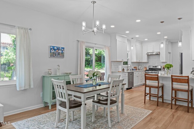 dining room with recessed lighting, baseboards, a chandelier, and light wood finished floors