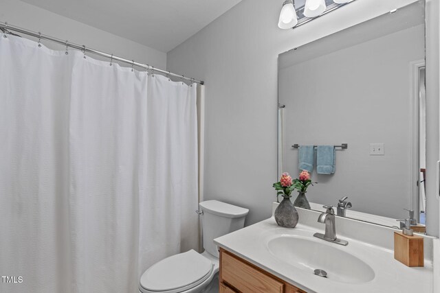 full bathroom featuring vanity and toilet